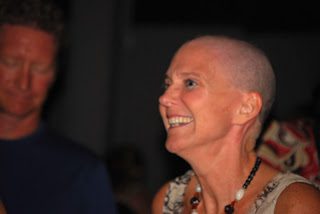 Smiling bald woman wearing necklace at event