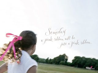 Child with pink ribbon gazing across grassy field