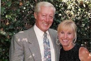 Smiling older couple posing outdoors