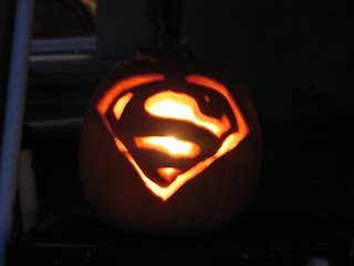 Glowing pumpkin carved with Superman emblem