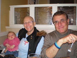Three people smiling at restaurant table