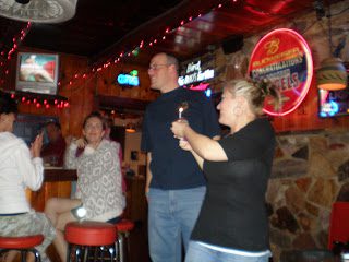 Group celebrating at dimly lit bar