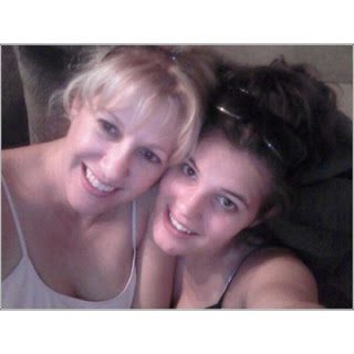 Two smiling women posing for close selfie