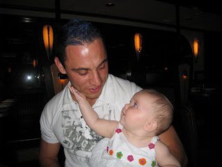 Man holding baby, baby reaches for his face
