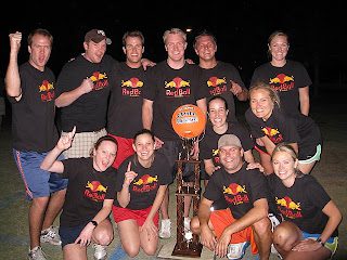 Smiling recreational basketball team with trophy