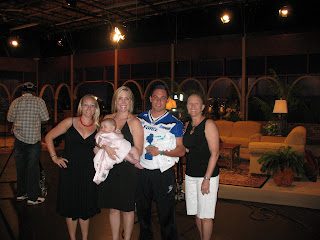 Four adults with two babies on studio set