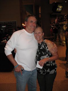 Smiling couple hugging indoors at event