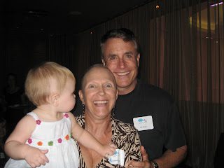Smiling man, woman, and toddler at event