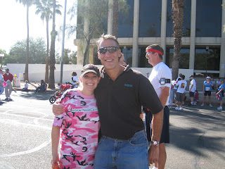 Two people smiling at outdoor charity event