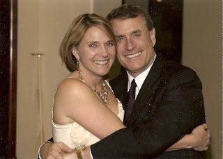Smiling couple embracing at indoor event