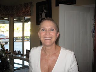 Smiling person in white top by window