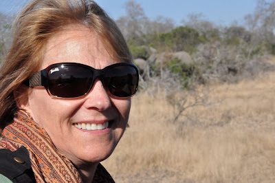 Smiling person wearing sunglasses outdoors