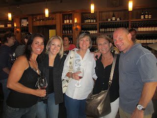 Group of friends smiling with wine glasses