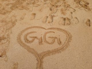Heart with "GiGi" written in sand