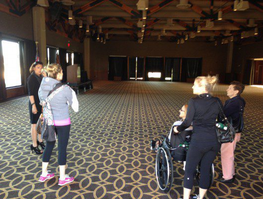 Group in large, empty carpeted room.