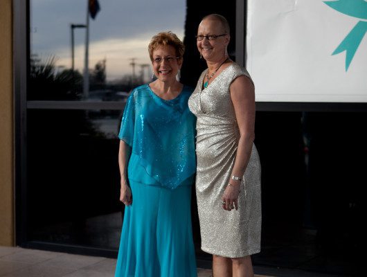 Two women in elegant evening dresses.