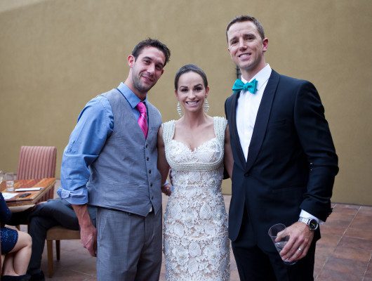 Three people posing at a formal event.