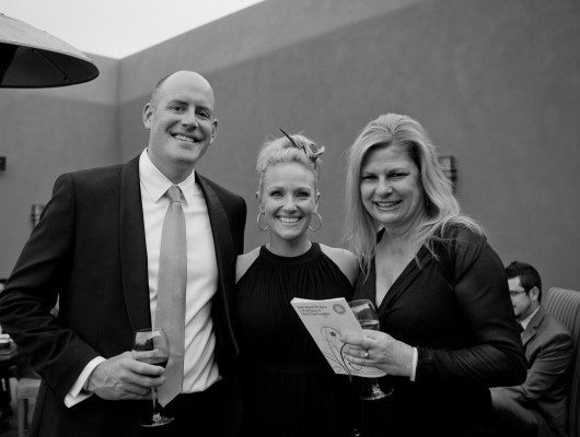 Three people posing at an event.