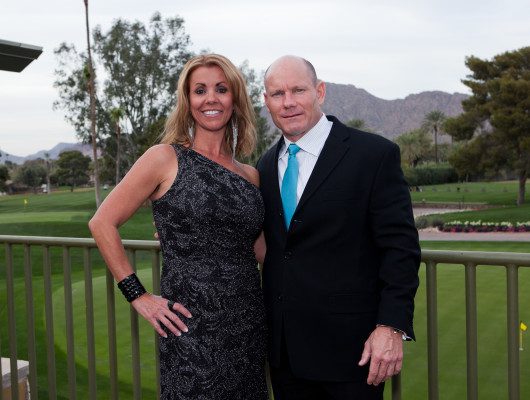 Man and woman posing outdoors together.