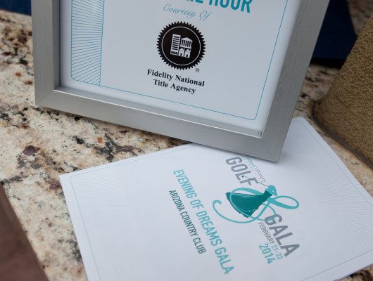 Framed cocktail hour sign on table.