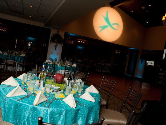 Elegant dining table with teal decorations.