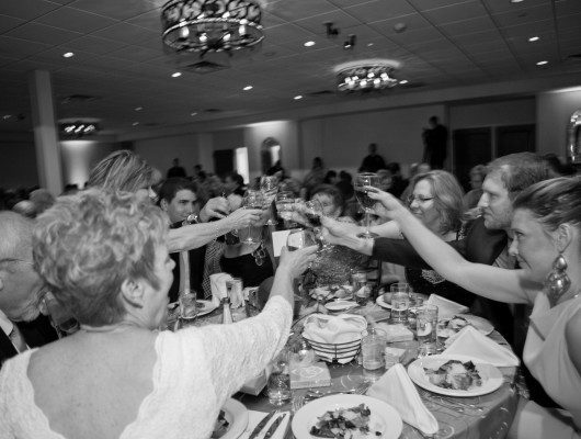 People toasting at a formal dinner event.