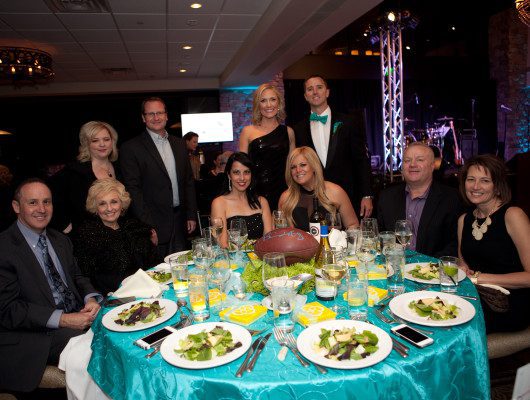 People dining at a formal event table.