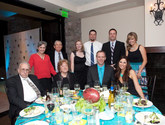 Group posing around a dinner table.