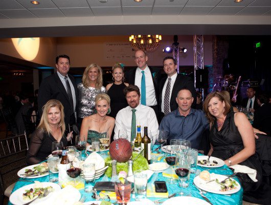 Group of people posing at a formal event.