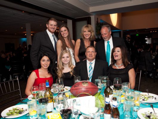 Group at formal dinner event with football.