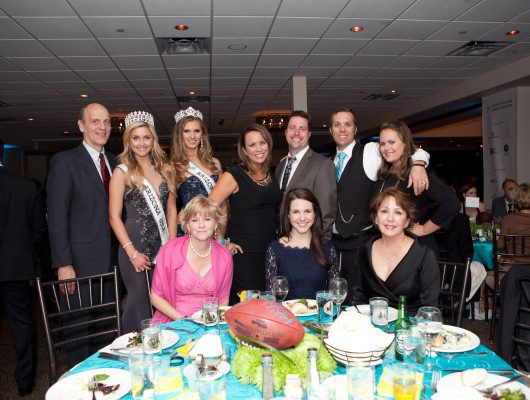 Group at formal event with table setting.