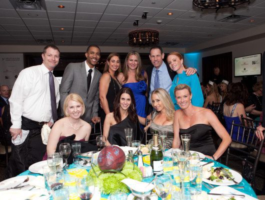 Group of people posing at a formal event.