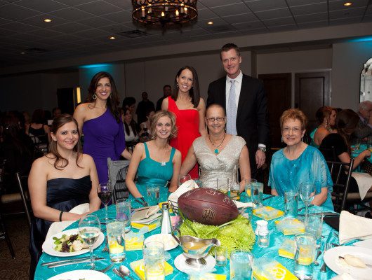 Group photo at a formal dinner event.