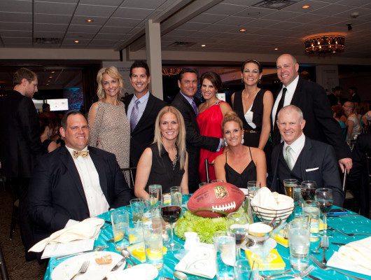 Group posing at formal dinner event.