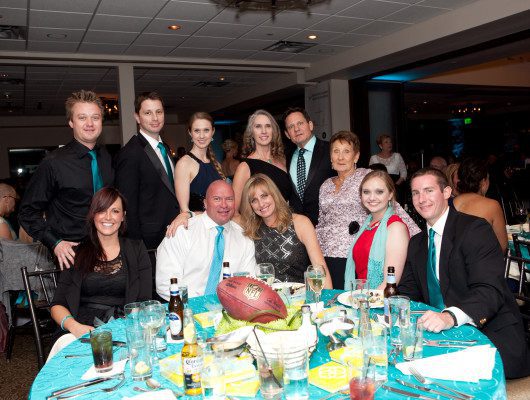 Group posing at a formal dinner event.
