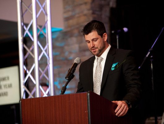 Man speaking at podium during event.