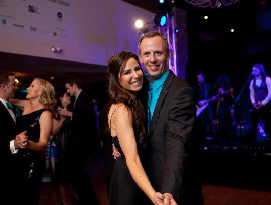 Couple dancing at a formal event.