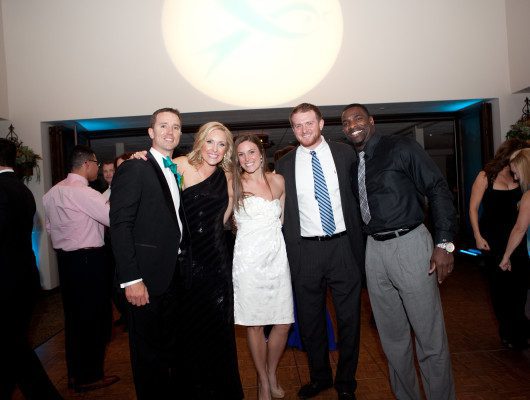 Group of people smiling at an event.