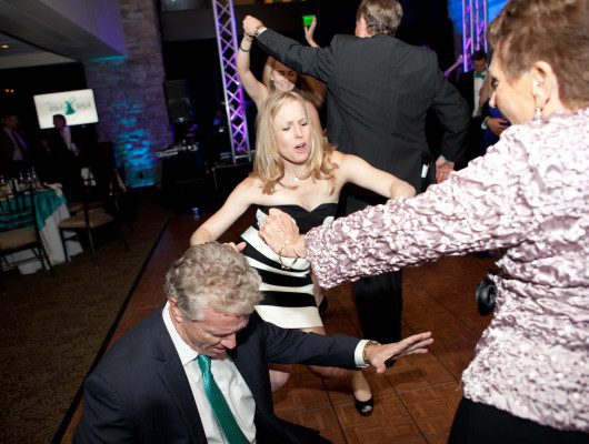 People dancing energetically at a party.