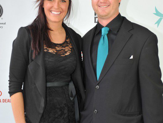 Two people posing at an event.