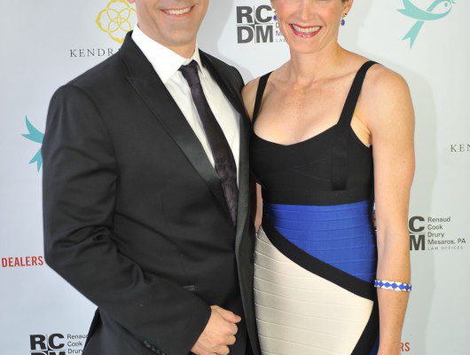 Man and woman posing at an event.