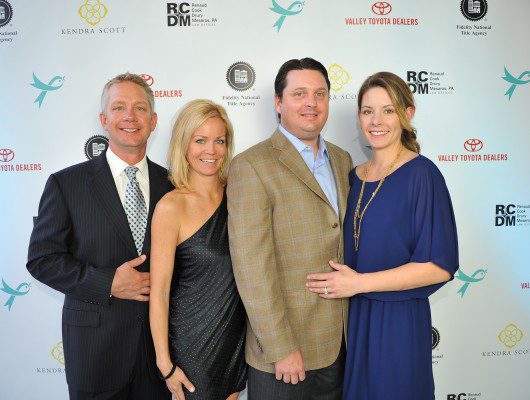 Four people posing at a formal event.