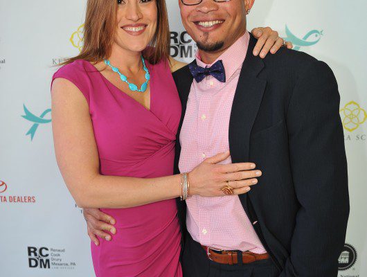 Smiling couple posing at an event.