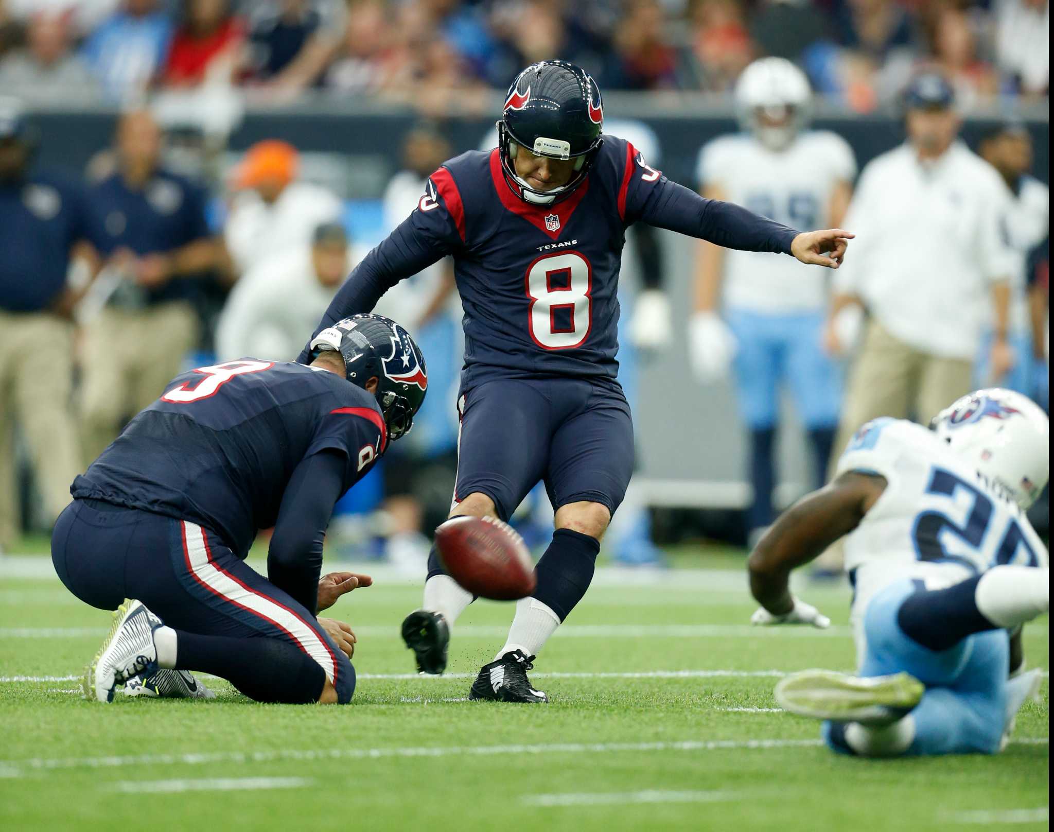 A football player, Nick Novak, is kicking the ball in a game.