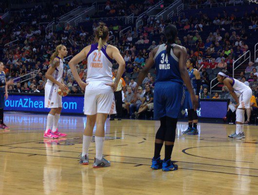 Basketball players preparing for free throw.