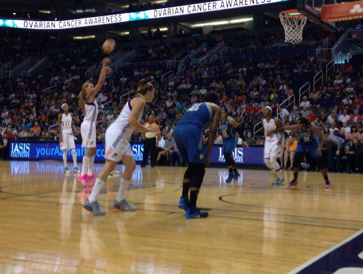Basketball game with players shooting freethrow.