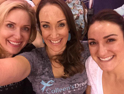 Three smiling women taking a selfie together.