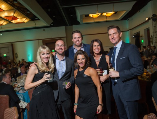 Group of people smiling at formal event.