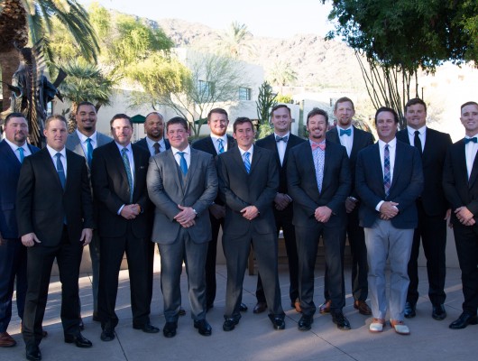 Group of men in suits outdoors.
