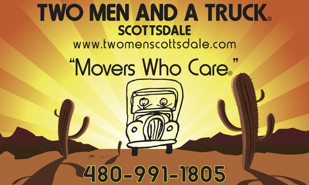 Two men driving truck in desert landscape.